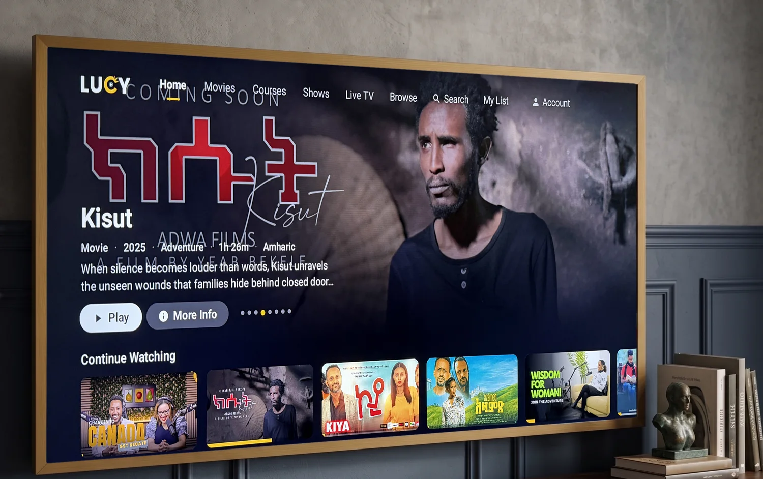 Lucy TV running on a wall-mounted television in a living room, showing the Kisut feature and a Continue Watching row